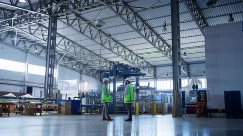 Factory Storage Employees Talking About Storehouse Delivery Boxes Inspecting. Professional Manufactu