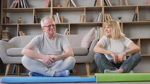 Senior Couple Talking Before Yoga at Home