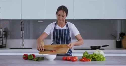 Woman Chopping Tomatoes in Modern Kitchen