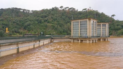 Sau pantano overflowing, january 2026 swollen river with muddy brown water flowing forcefully