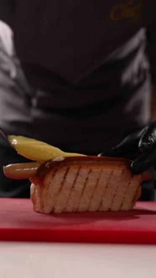 A chef prepares delicious hot dogs in a restaurant.