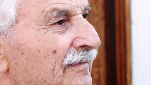 Close-Up Portrait Of senior Man Looking Out Over