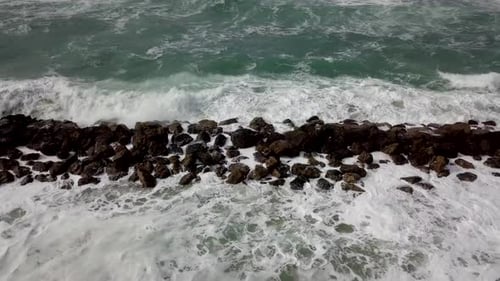 Waves Crashing Over Rocks on Ocean Shoreline