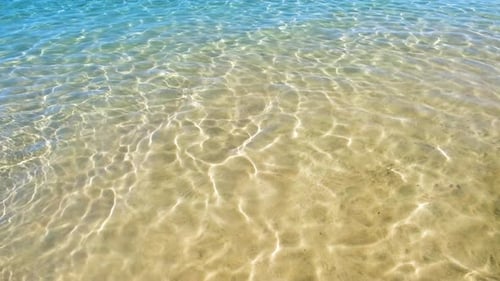 Seascape with Surface of Blue Sea Water with Small Ripple Waves Crashing on Yellow Sandy Beach