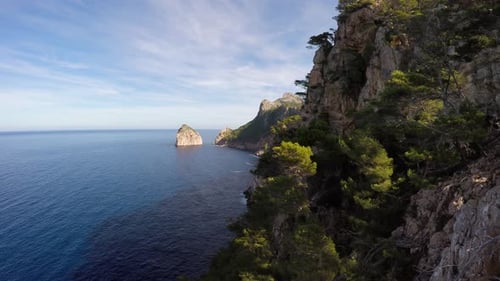 flying along coastline overlooking stone rocks seascape background
