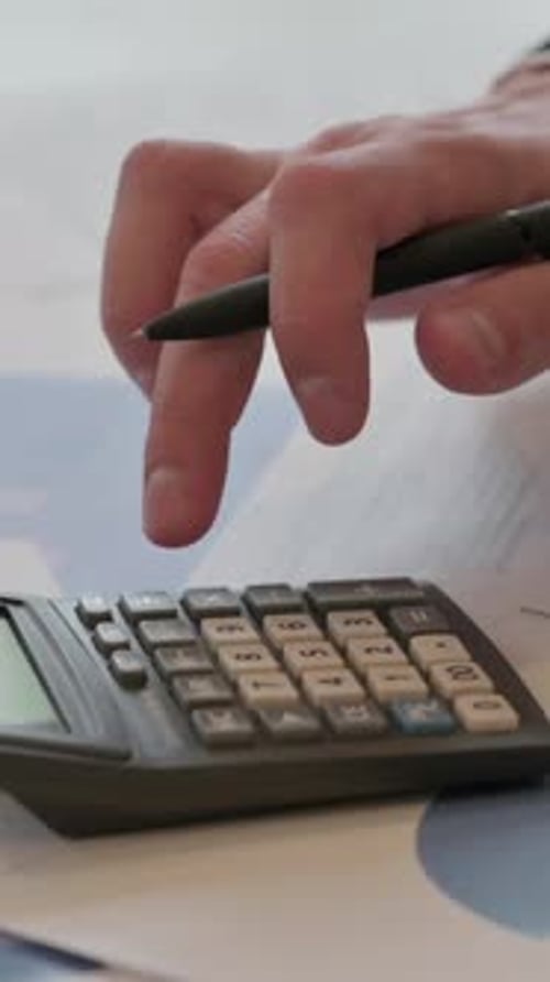 Close up of Middle Aged Businessman making Calculations, Writing on Paper, Vertical Video