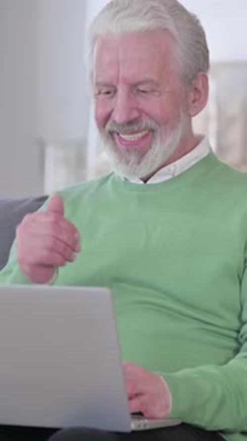 Senior Man Video Calling on Laptop at Home