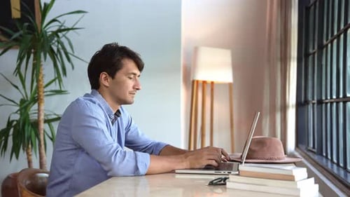 Business Man Working in Home Office and Typing on Keyboard of Laptop Computer
