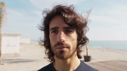 Man with Wavy Hair on Beach Close Up
