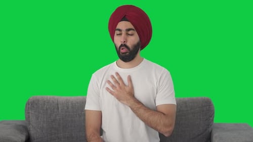 Sick Sikh Indian man having an Asthma attack Green screen