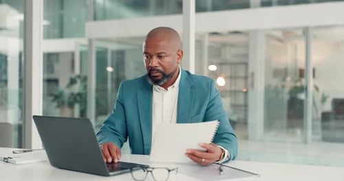 Business, documents and black man in office, laptop and financial agent with tax audit