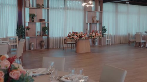 Decorated Reception Hall with Tables and Floral Centerpiece