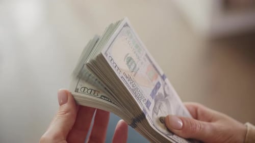 Close Up of Hands with Stack of Money