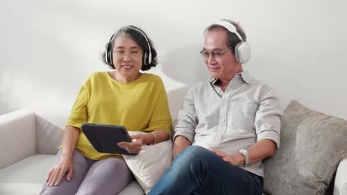 Senior Couple Relaxing at Home with Tablet