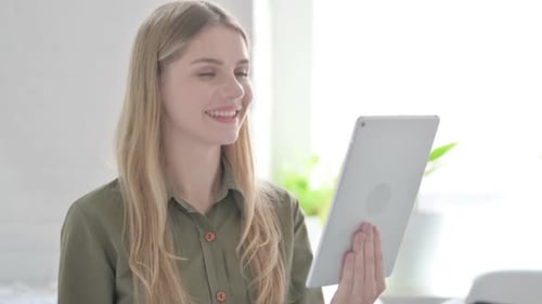 Woman Using Tablet for Video Call in Home