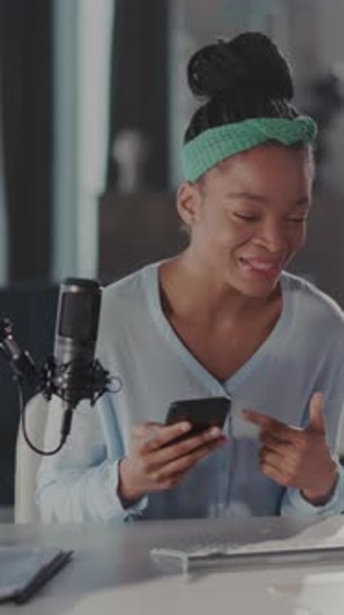 Attractive Woman Vlogging with Mobile Phone at Desk
