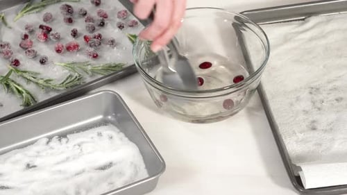 Step By Step Covering Fresh Cranberries and Rosemary in Sugar to Decorate Chocolate Bundt Cake with