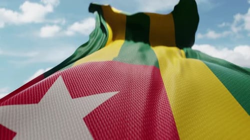 Togo National Flag Waving in Wind with Blue Sky
