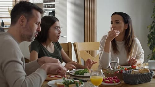 Family Eating Together and Talking at Home