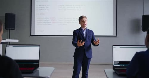 Future IT Professional Teen Boy Speaking In Modern Classroom In Middle School Presenting Project