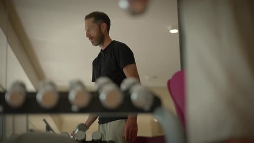 A Man is Intensely Working Out at the Gym Focusing on His Fitness Goals and Health