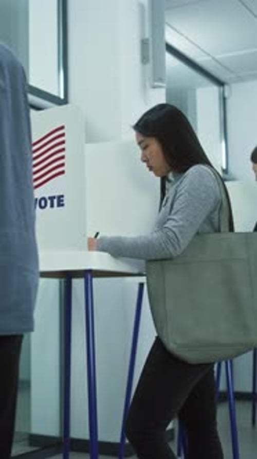 Multicultural American Citizens Vote in Booths in Polling Station
