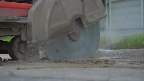 Close Up Shot of Cutting Saw on Tarmac to Cut a Road Surface for Repair Slow Motion Footage