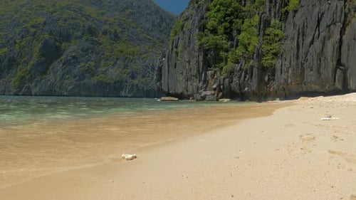 Seascape Ocean and Beautiful Beach Rocks on Sandy Beach with Blue Sea Waves on Sunny Day Palawan