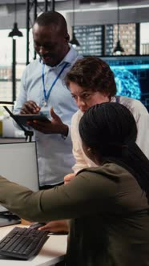 Vertical Video Team of Software Developers in Office Working Together Automating Using AI