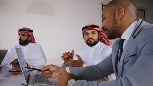 Men in Business Meeting Discussing Laptop