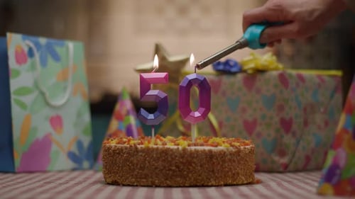 Number 50 Candle on Birthday Cake with Gifts 50Th Anniversary