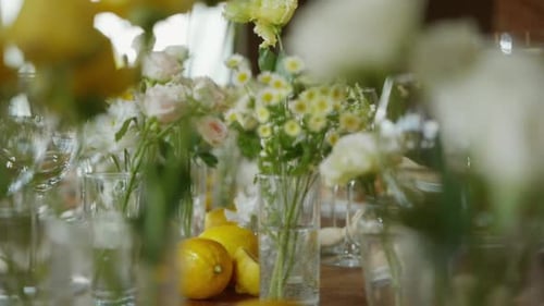 A Closeup of a Wedding Table Decorated with Fresh Flowers and Lemons