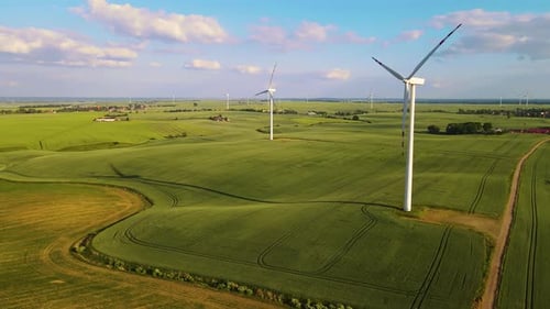 Wind Generator Converts Wind Into Electrical Energy Farm Windmill in Action Amidst Agricultural