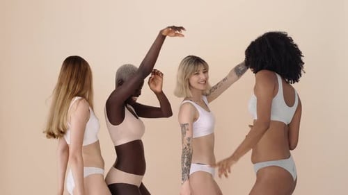 Four Diverse Women Dance Together Confidently in Underwear