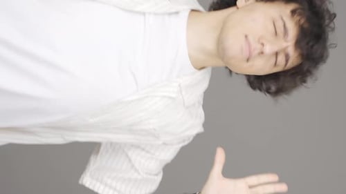 Vertical video of Fun young man dancing.