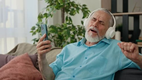 Senior Man Listening to Music on Headphones