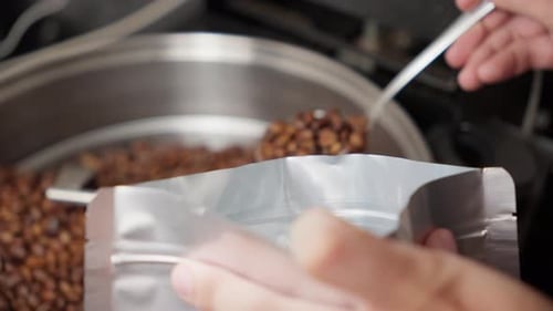 Scooping Roasted Coffee Beans into a Bag