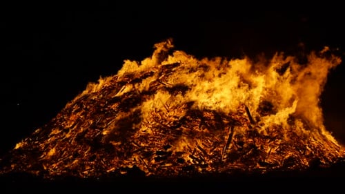 Wide shot of a huge bonfire burning in slow motion, shot in 180fps. Guy Fawkes night, 5th of Novembe