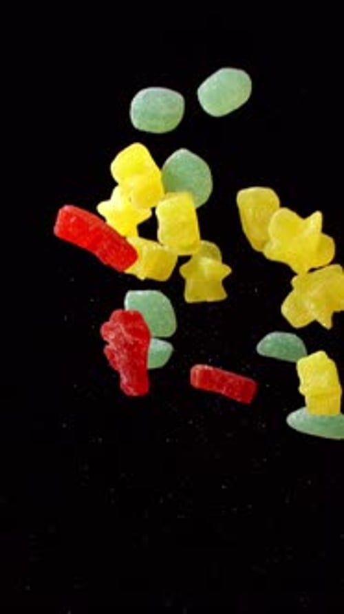 Gummy Candies Falling in Slow Motion on Black