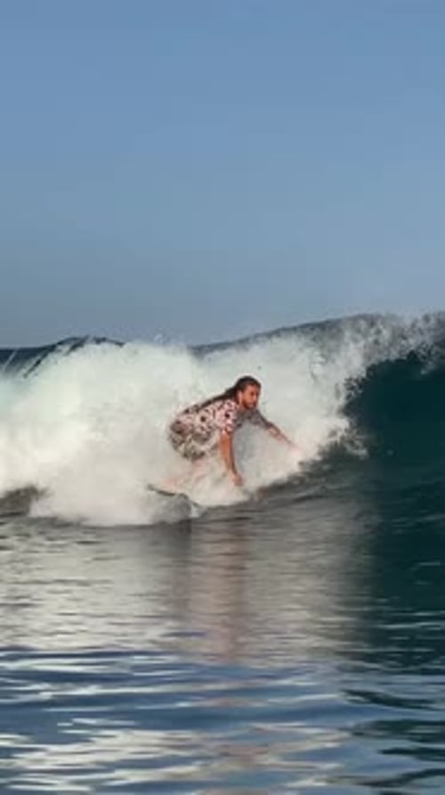 Young Guy Surfs in the Ocean