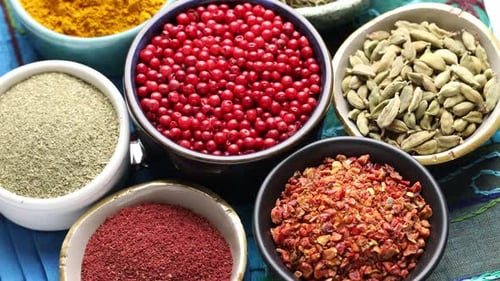 Colorful bowls of spices with zoom camera movement