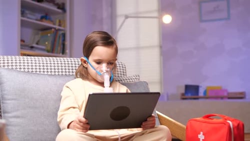 Young Child Using Nebulizer While Watching Tablet