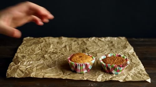 Muffins on Wrinkled Parchment Paper and Dark Background