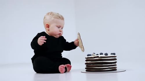 Adorable Infant Celebrates First Birthday With Cake
