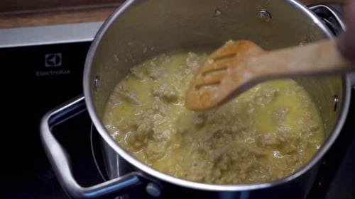 Close Up Shot of Hand Stirring Minced Meat in a Pot