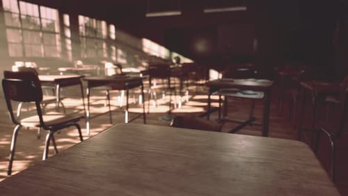 View to Classroom with Tables and Small Blackboard and Grungy Walls