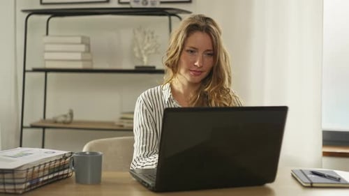Caucasian Woman Typing on Laptop Keyboard in Home Office