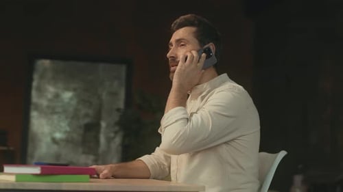 Bearded Businessman Sitting at Desk Talking on Phone Have Conversation on Smartphone Modern Office