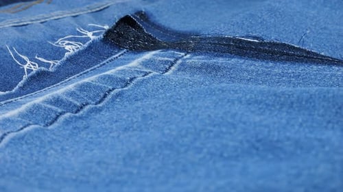 Close-Up of Blue Denim Fabric With Stitching