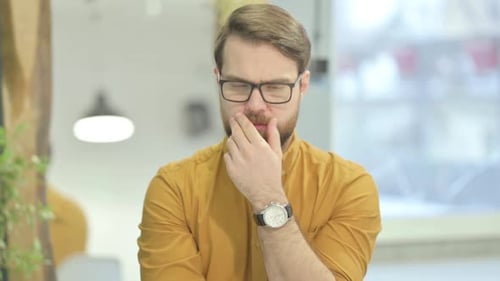 Man with Glasses Deep in Thought Indoors